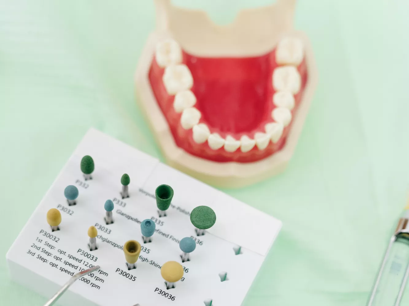 A dentist examining dental burs.